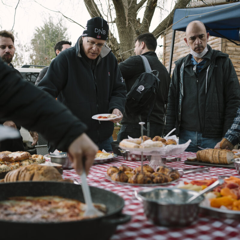 People taking food on a picnic table
